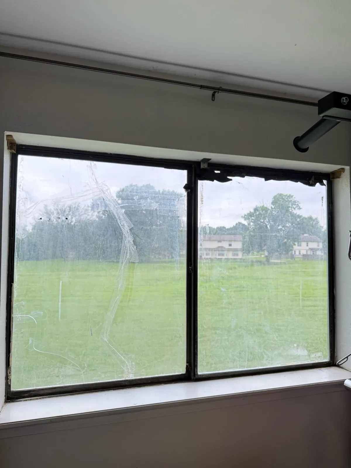 Before: an old, worn sliding window ready for replacement in an Oklahoma home