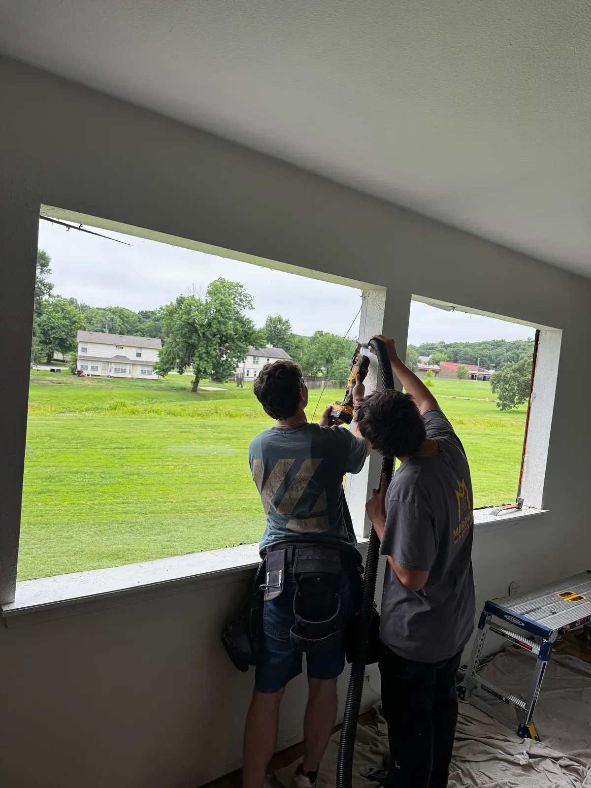 Morgan Windows installers setting a new window in a large opening